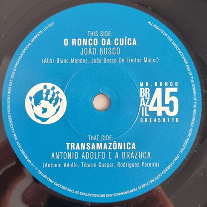 João Bosco / Antonio Adolfo E A Brazuca - O Ronco Da Cuíca / Transamazônica (7", Single, RE)